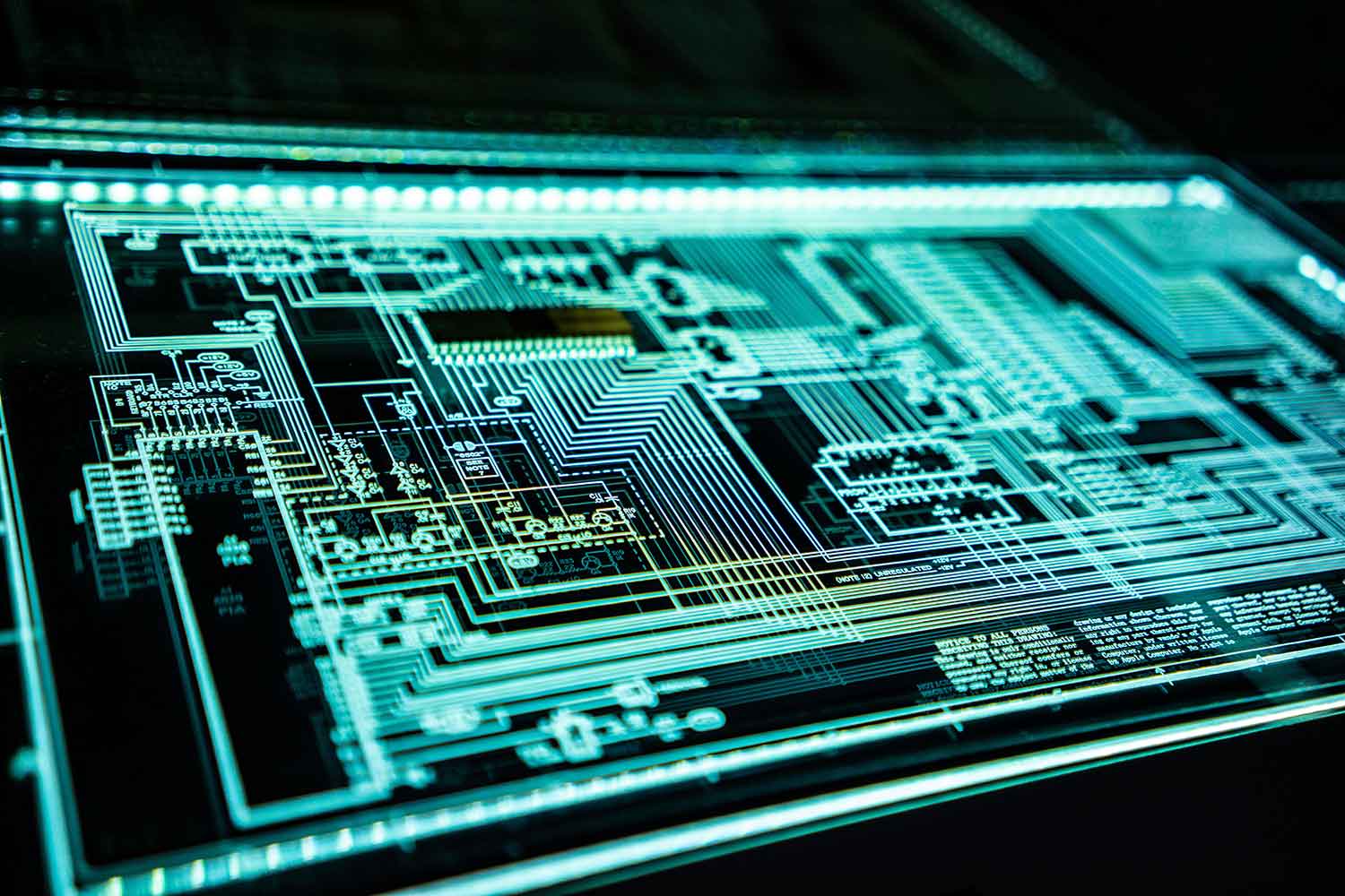 Illuminated circuit diagram design with complex circuit paths and electronic components on a digital screen.