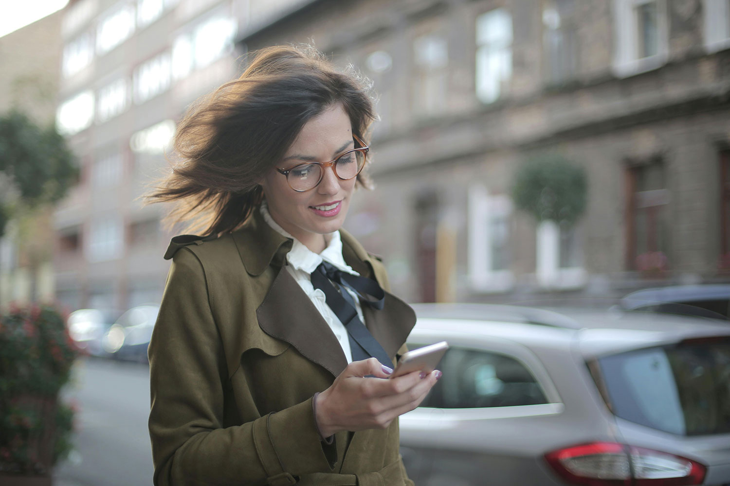 Lächelnde junge Frau nutzt Handy-App für digitale Verwaltungsdienste. | Quelle: Pexels by Andrea Piacquadio