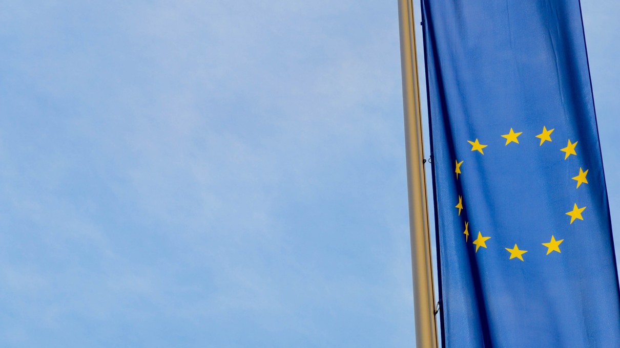 Flag of the European Union against a blue background. 