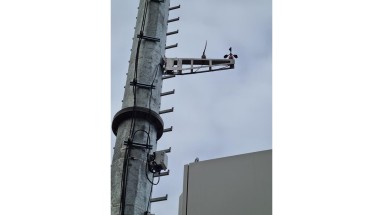 Detailed image of a communication mast with sensors attached.