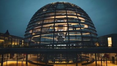 Illuminated glass dome at night.